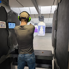 man firing handgun at HOT shooting range